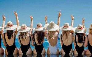 women in bikinis wearing Moroccan hats for a hen party