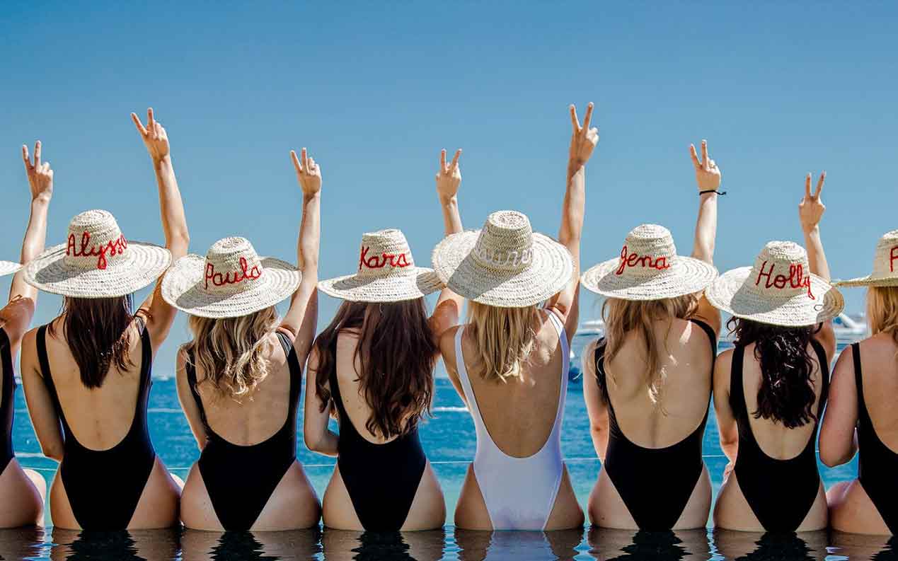 women in bikinis wearing Moroccan hats for a hen party